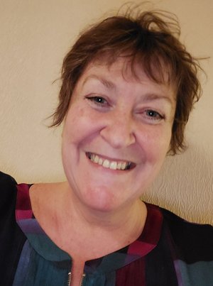 Picture of Stephanie Joy Phillips, multi-colored dress, short red hair, big smile